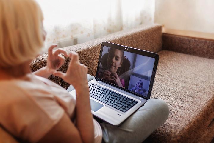 Older woman video chatting with a young girl