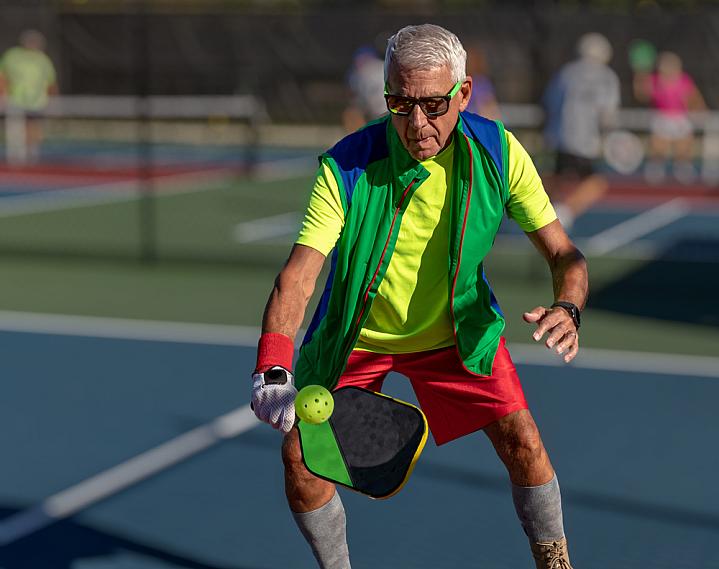 Older man playing pickleball