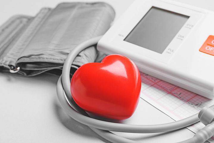 Modern blood pressure monitor with red heart