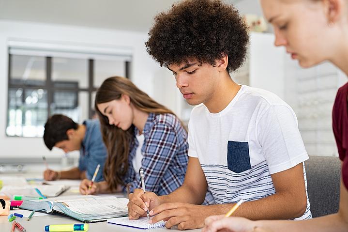 Two high school students doing school work in class.