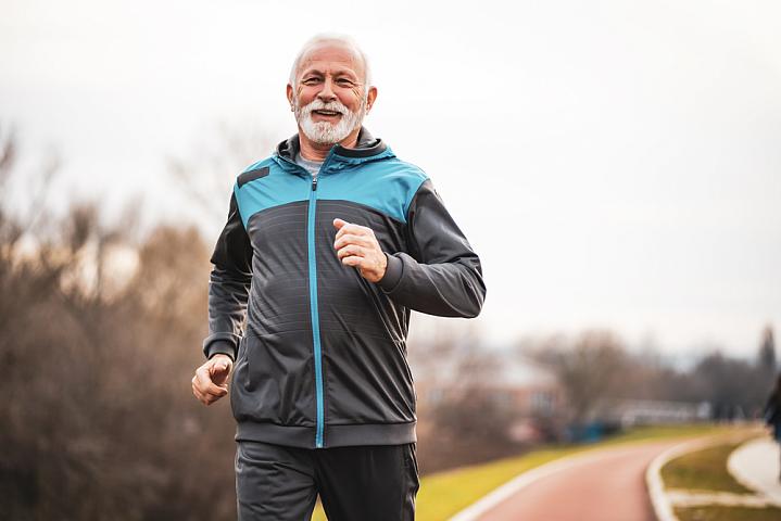 Older man jogging outside.