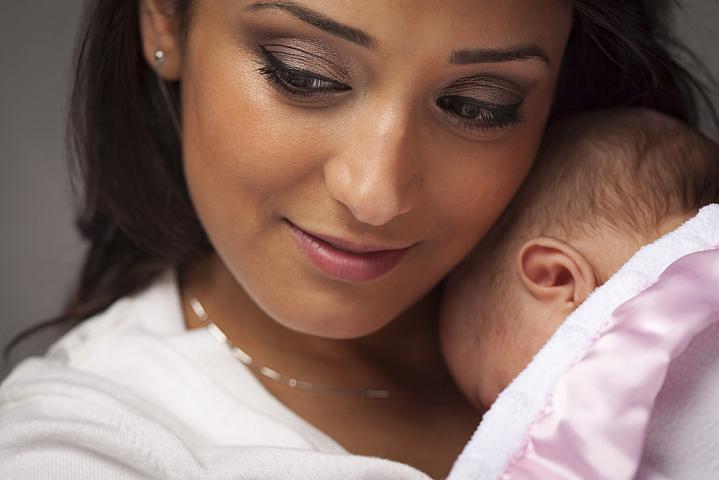 Woman holding a newborn.